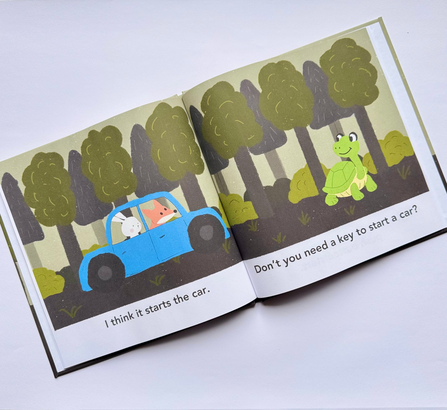 Open book with illustrations of a fox and a rabbit in a car in a forest