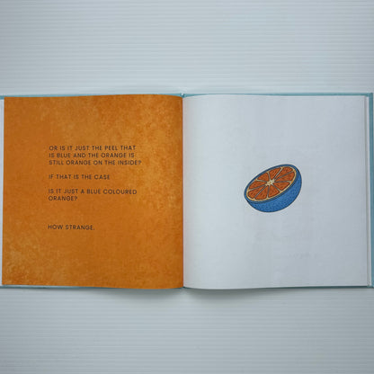 Open book with text and a blue orange